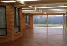 Flat roofed verandah with Classoc Cream COLORBOND V Deck 3P roof sheets, Merbau Decking & Full Tracked PVC Patio Blinds. Tarneit 2