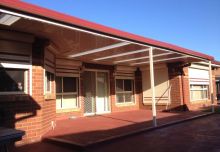 Custom Flat Roofed Patio wrapped around a Bay Window