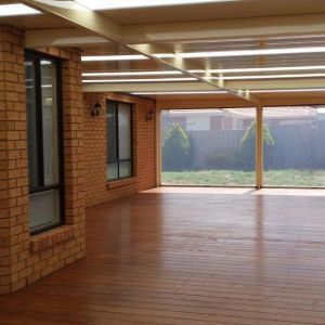 Flat roofed verandah with Classoc Cream COLORBOND V Deck 3P roof sheets, Merbau Decking & Full Tracked PVC Patio Blinds. Tarneit 2