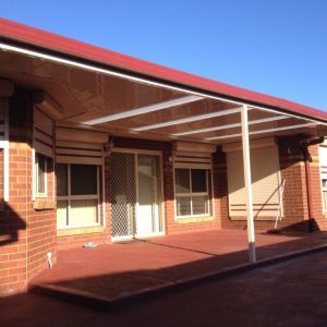 Custom Flat Roofed Patio wrapped around a Bay Window